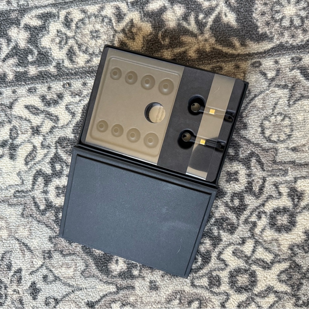 Master & Dynamic - Black and Gold Earbuds with Case.